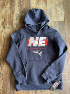 a new england football hoodie is laying on the floor