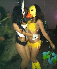 two women dressed up in costumes and rubber boots, one with a duck mask on