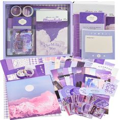 an assortment of purple and white items in a binder, including notebooks, cards, and magnets