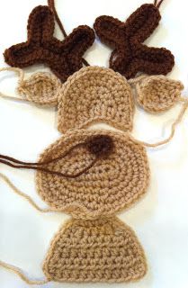 three crocheted monkey heads with leaves on them