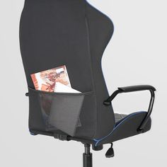 an office chair with a magazine holder on it's back and the seat up