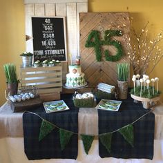 a table topped with cakes and desserts covered in grass