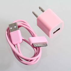 an apple charger and usb cable attached to a pink wall charger on a white surface