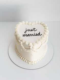 a heart shaped cake with the words just married written on it