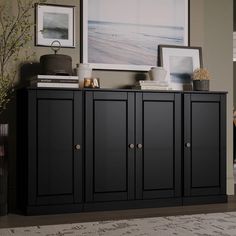 a black cabinet in a living room with pictures on the wall