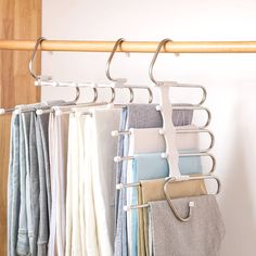 several folded towels are hanging on a rail