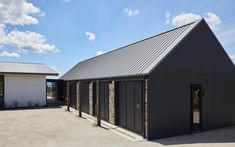 two garages with doors open in front of them