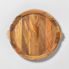 a round wooden plate on a white background