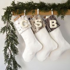 three christmas stockings hanging on a clothesline with the word bsb written in them