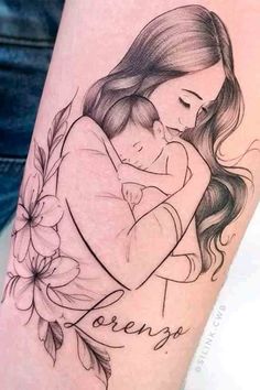 a woman with a tattoo on her arm holding a baby