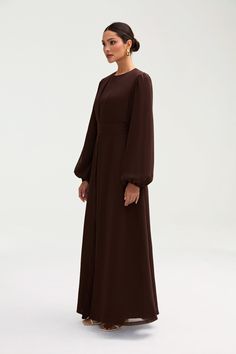 Effortlessly elegant, the Najma Chiffon Abaya & Dress Set is the epitome of luxury. Made from delicate chiffon, this two piece set features a timeless abaya and a sleeveless dress, both in a rich cocoa brown hue. The removable belt adds a touch of sophistication to this must-have addition to your wardrobe. Model is 5'7 wearing size XS/58" Long Sleeved Dress, Abaya Designs, Cocoa Brown, Abaya Dress, Dress Set, Two Piece Set, Modest Dresses, Modest Fashion, Set Dress