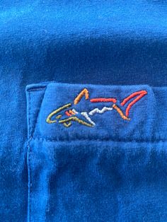 Greg Norman Collection Golf Shark T-Shirt ** Royal Blue **  Fits like a Medium.  See pics for measurements  Australian Golfer  Cool Colorful Logo Fine condition  Quick shipping. We ship same or next day with USPS mail  We are a small family business and we appreciate your purchase, Godspeed !  DS Pre-shrunk Blue Crew T-shirt, Casual Blue Tops With Embroidered Logo, Blue Casual Top With Embroidered Logo, Casual Blue Top With Embroidered Logo, Blue Cotton T-shirt With Embroidered Logo, Blue Pre-shrunk Crew T-shirt, Blue Graphic Tee With Embroidered Logo, Blue Cotton Crew T-shirt, Blue Crew Neck Top With Graphic Print