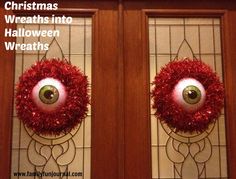 two christmas wreaths decorated with fake eyes and red tinsel are on the front door