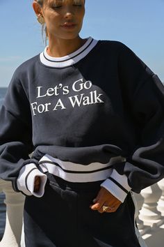 Let's go for a walk. For a minute or a mile, this oversized fleece is here to fuel inspiration on your daily journey. Featuring simple yet quality thick puff printing in a classic white coloring. Let's Go For A Walk design on chest in simple text Dark navy coloring Thick puff printing Wear with the Tearaway Fleece Pants in Navy Ribbed trim along wrists, neck, and waistband Soft, fuzzy interior Measurements for size S — bust: 52 inches, length: 24 inches This sweatshirt is made from 100% recycled Oversized Sweatshirt Outfit, Sweat Oversize, Minimal Shirt Design, Oversize Tshirt Outfits, Go For A Walk, Womens Crewneck, Tennis Clothes, Tshirt Outfits, Tee Outfit