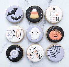 halloween decorated cookies arranged on a marble surface