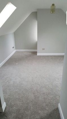 an empty room with white walls and carpeted flooring is shown in this image