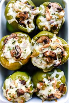 green peppers stuffed with mushrooms and cheese in a casserole dish