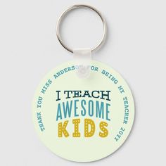 a round keychain with the words i teach awesome kids on it's side