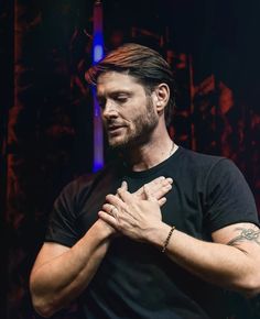 a man holding his hands together in prayer