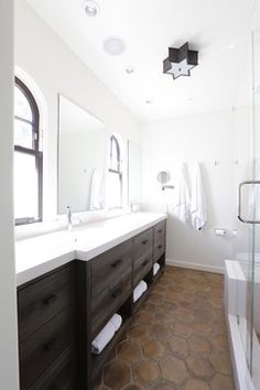 a large bathroom with two sinks and mirrors