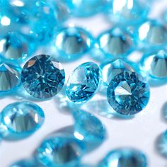 many blue diamonds are scattered on a white surface