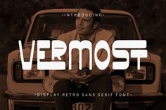 a man sitting in front of a car with the words vermost on it