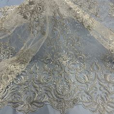 the fabric has been embroidered with silver thread and sequins on it's edges