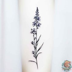 a black and white flower tattoo on the side of a woman's leg,