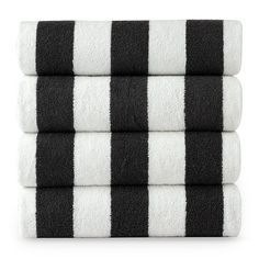 three black and white striped towels stacked on top of each other in front of a white background