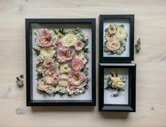 three framed pictures with flowers in them on a table