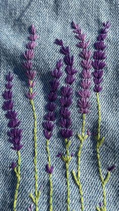 some purple flowers are sitting on a blue cloth