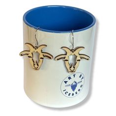 two rams are hanging from the side of a mug