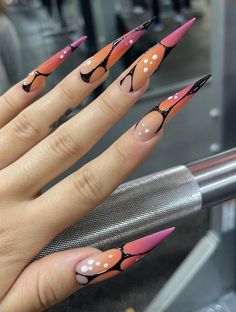 a woman's hand with pink and black nail designs