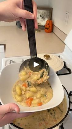 a person holding a ladle full of soup