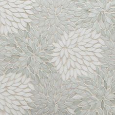 a white and grey wallpaper with large leaves on the top, as well as an intricate design