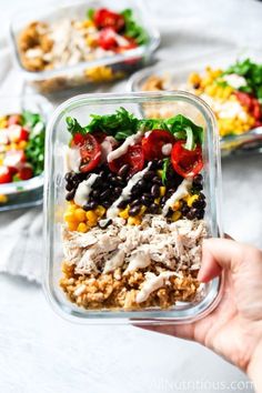 a person holding up a container filled with food