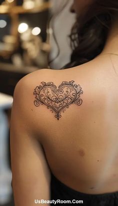 a woman with a heart tattoo on her shoulder