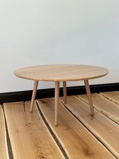 a wooden table sitting on top of a hard wood floor