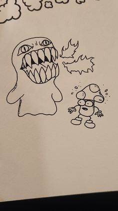 a drawing of a cartoon character with an angry face and mouth is shown on a piece of paper