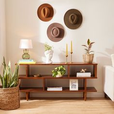 a living room with three hats on the wall