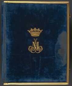 an old blue book with gold lettering and a crown on it