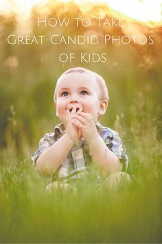 a young boy is sitting in the grass with his hands over his mouth and looking at the camera