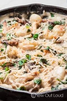 a skillet filled with pasta and vegetables