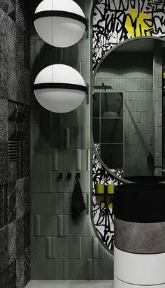 the bathroom is decorated in black and white with lots of graffiti on the wall behind it