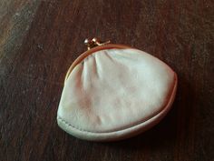 This  small super soft leather French Coin Purse is a wonderful antique accessory to hold your coins or other small trinkets in your purse. It would have been used in the early 1900s to hold coins for alms, tipping or purchases. The exterior of the coin purse is made of quality leather in ecru white. There is a gold metal kiss lock clasp that closes securely. The interior is lined in white silk taffeta lining.   It measures: 7 cm (2 3/4 inches) wide at its widest and 5.5 cm (2 1/4 inches) from b Classic Beige Coin Purse As Gift, Classic Gold Coin Purse For Daily Use, Classic Gold Coin Purse For Everyday Use, Compact Gold Coin Purse With Coin Pocket, Compact Gold Coin Purse, Gold Coin Purse With Coin Pocket For Formal Occasions, Classic Gold Coin Purse As Gift, Gold Coin Purse With Coin Pocket As A Gift, Formal Gold Coin Purse With Coin Pocket