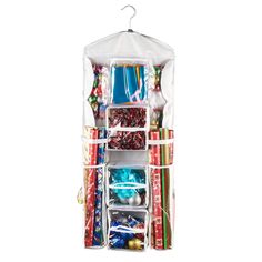 the hanging storage bag is filled with christmas presents and other holiday items, including candy bars