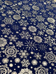 snowflakes on a blue background with gold foil