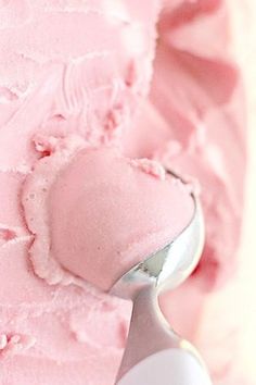 a scoop of pink ice cream sitting on top of a table