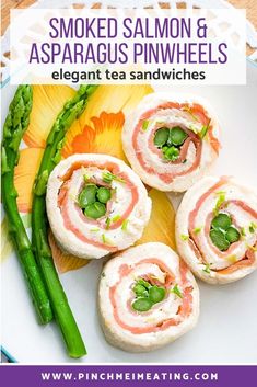 a plate topped with asparagus and spinach pinwheels next to green beans