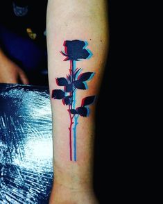 a black and red rose tattoo on the arm